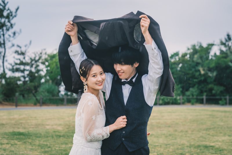 屋外で雨の中寄り添う男女